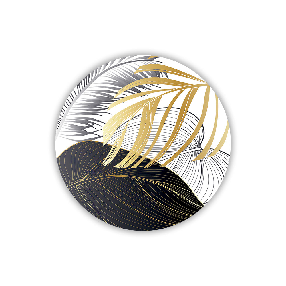 Magnete in legno con decorazione grafica di foglie tropicali dorate e argentate su fondo scuro, dal design moderno ed elegante.