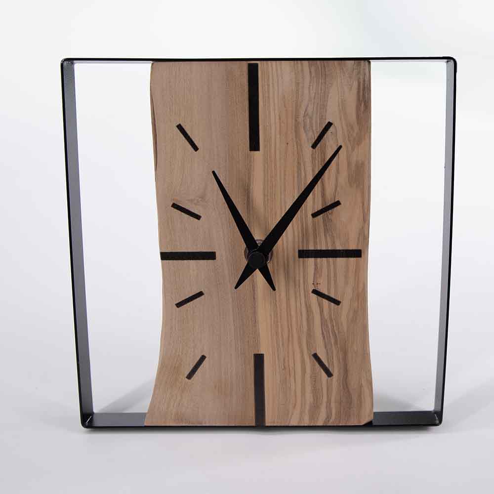 Orologio ulivo acciaio da tavolo, foto frontale con focus sulle lancette e sulla superficie del legno.