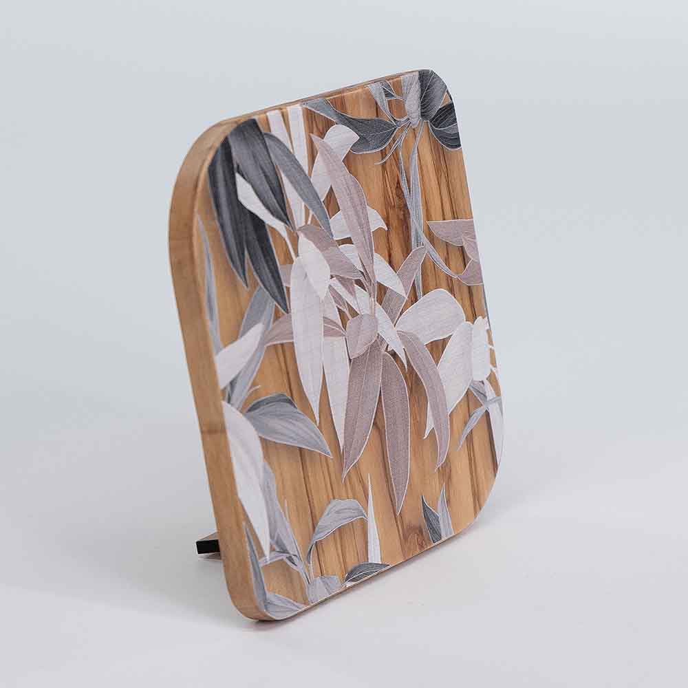 Vista laterale di un quadretto in legno d'ulivo con decoro di foglie miste, che evidenzia lo spessore del materiale.