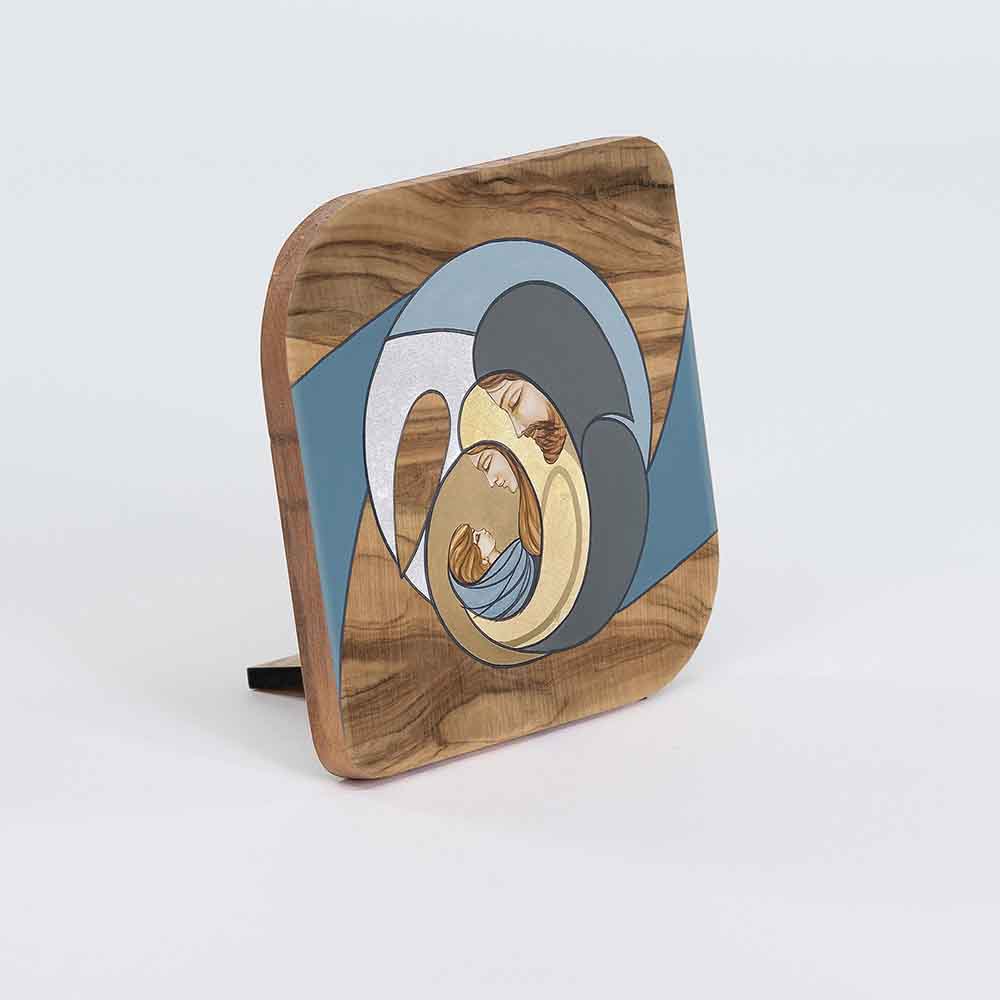 Vista laterale di un quadretto in legno d'ulivo con decorazione colorata della Sacra Famiglia, che evidenzia il bordo lavorato.