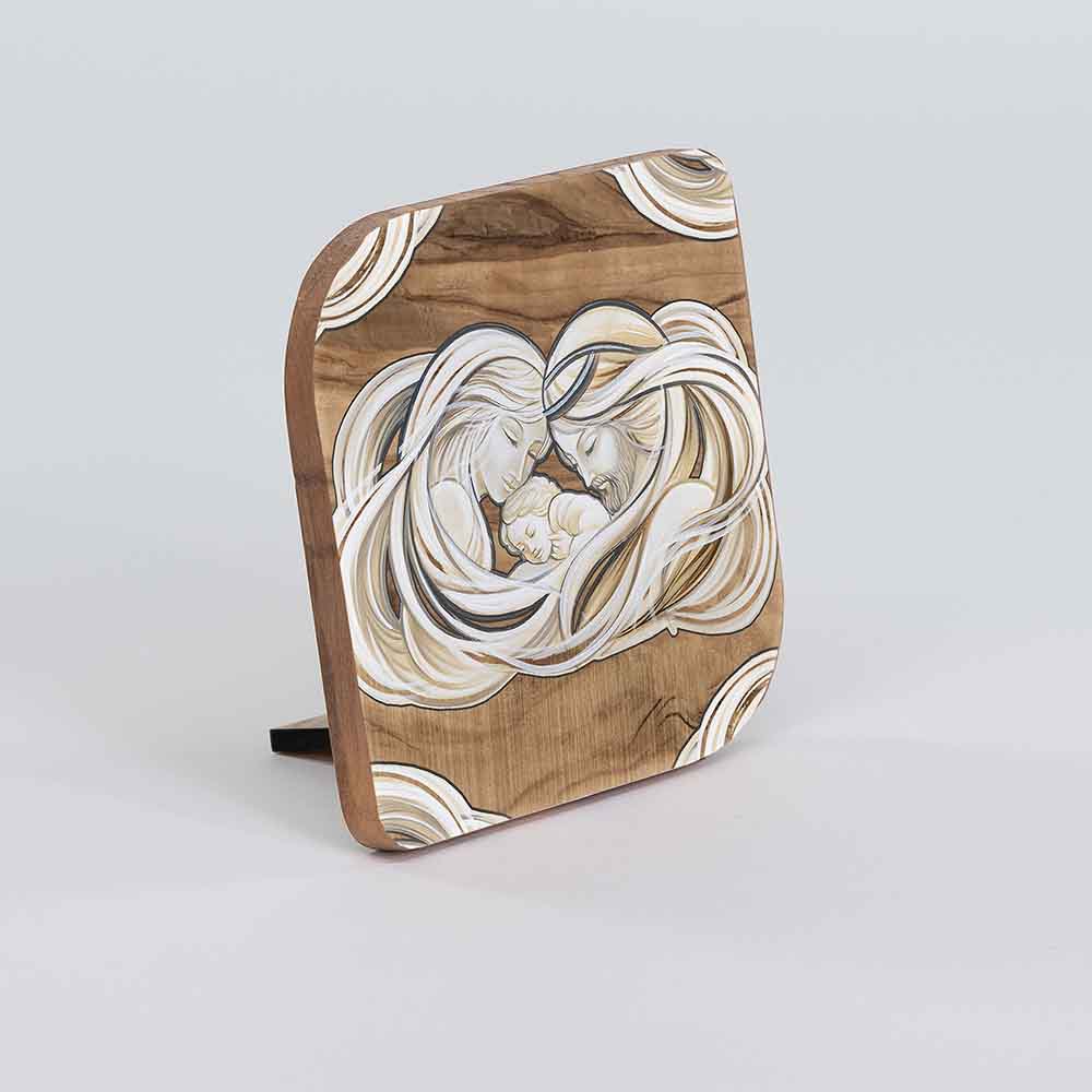 Vista laterale di un quadretto in legno d'ulivo con immagine della Sacra Famiglia, mostrando la profondità e il bordo.