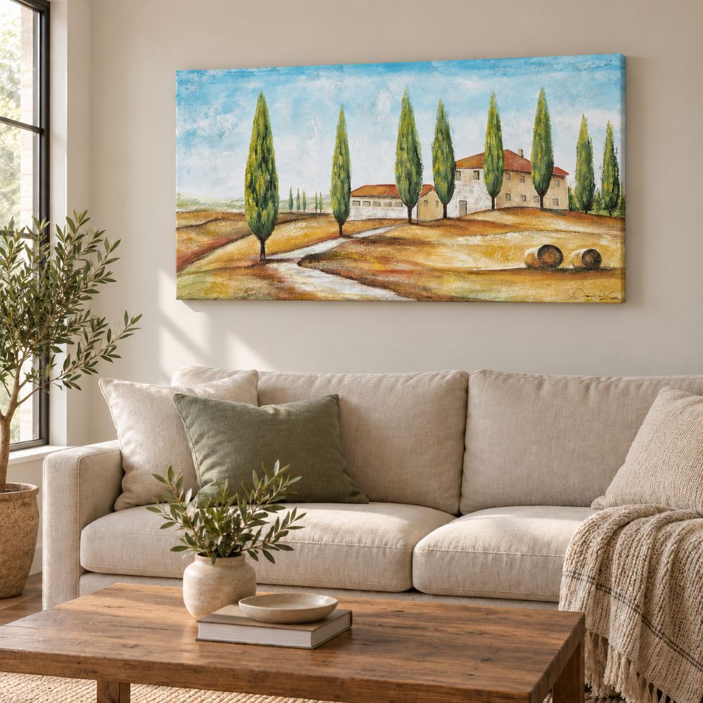 Quadro Cipressi dipinto a mano, ambientato in un soggiorno semplice e luminoso con arredi neutri e dettagli naturali.