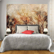 Quadro su tela grande con foliage autunnale nei toni caldi, collocato in una camera accogliente.