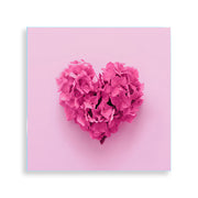 Quadro su vetro quadrato con un grande cuore rosa composto da fiori, dal look romantico e minimalista.