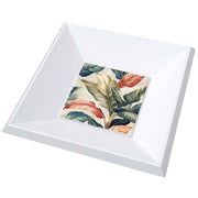 Vassoio in legno con ceramica decorata con foglie tropicali dai colori caldi e dettagli accurati, evocando atmosfere esotiche.