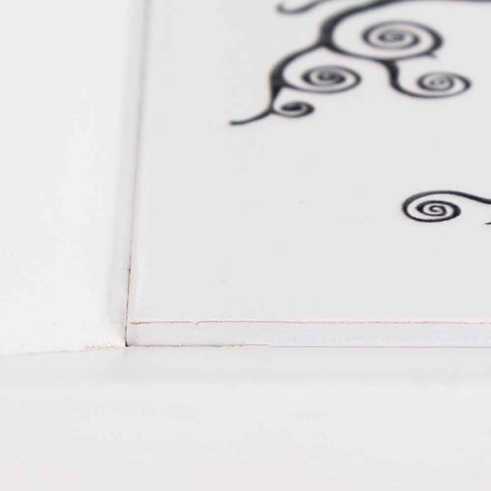 Dettaglio del vassoio in legno con ceramica, evidenziando l'incontro tra la cornice in legno naturale e la superficie decorata in ceramica.